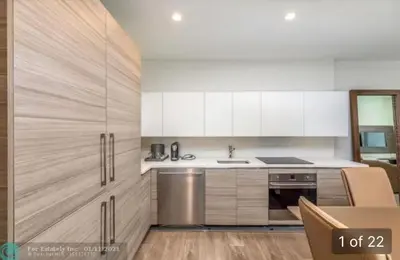 a kitchen with white cabinets and a sink at Ocean Dream at Costa Hollywood in Hollywood