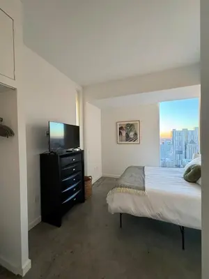 a bedroom with a bed and a flat screen tv at Elevated Elegance Luxe View Pool Free Parking in Miami