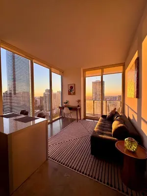a living room with a couch and large windows at Elevated Elegance Luxe View Pool Free Parking in Miami
