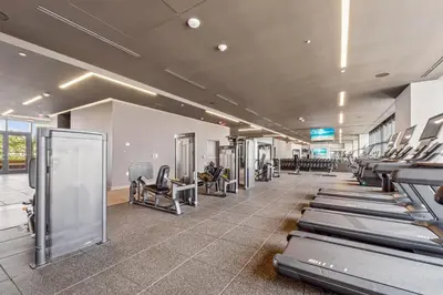 a gym with rows of treadmills and machines at Exclusive Studio with City Views in Downtown Miami in Miami