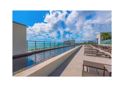 a swimming pool on the side of a resort at A Fantastic apart with balcony and partial view of the beach 4 Px in Hollywood