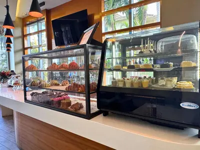 a bakery with a display case filled with different types of pastries at Luxury 3 bedroom condo with pool in Hallandale Beach