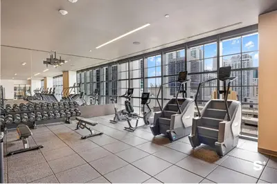 a gym with treadmills and ellipticals in a building at Modern Studio in Downtown Miami with Stunning City Views in Miami