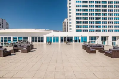 a large patio with chairs and tables and buildings at Shine Suites Balcony Duplex 9 in Miami Beach