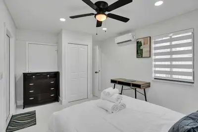 a bedroom with a bed and a ceiling fan at Serene Suite Near Aventura in Ives Estates