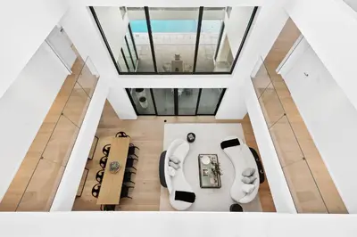 an overhead view of a living room with white furniture at Luxury 6-Bedroom Villa stunning 3-story estate in Golden Beach