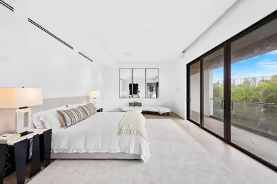 a white bedroom with a large bed and a large window at Luxury 6-Bedroom Villa stunning 3-story estate in Golden Beach
