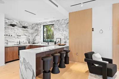 a kitchen with a stone wall at Luxury 6-Bedroom Villa stunning 3-story estate in Golden Beach