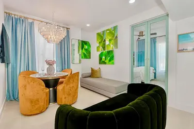 a living room with a couch and a table at 2-Min to Beach, Upscale Enclave in Miami Beach