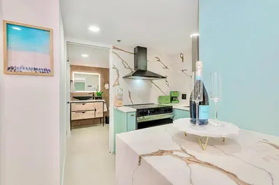 a kitchen with a bottle of wine on a counter at 2-Min to Beach, Upscale Enclave in Miami Beach