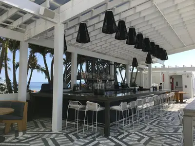 a bar on the beach with chairs and lights at Luxury Beachfront Two Bedroom Condo - W Residences in Fort Lauderdale