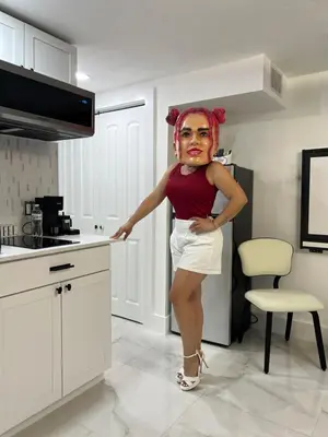 a woman is standing in a kitchen at AMIRI Hollywood 5 mins from Hard Rock Stadium & The Guitar in Hollywood
