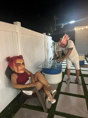 a man and a woman sitting on a chair on a patio at AMIRI Hollywood 5 mins from Hard Rock Stadium & The Guitar in Hollywood