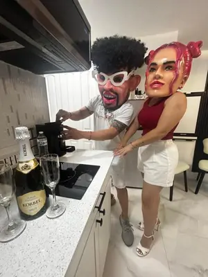a man and a woman standing in a kitchen with a mask at AMIRI Hollywood 5 mins from Hard Rock Stadium & The Guitar in Hollywood