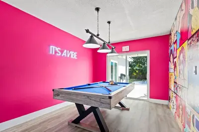 a pool table in a room with a pink wall at Pool, golf & 4 mi. from the beach & The Hard Rock in Hollywood