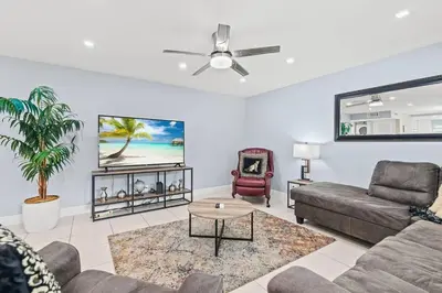 a living room with a couch and a ceiling fan at Beach, Pool & Las Olas Getaway in Fort Lauderdale