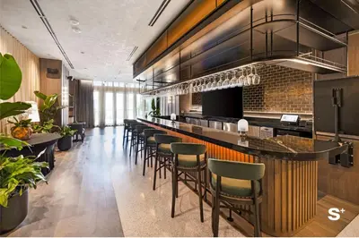 a bar with a bunch of stools in a restaurant at City Luxe Retreat Modern 2-BD with Water Views in Miami
