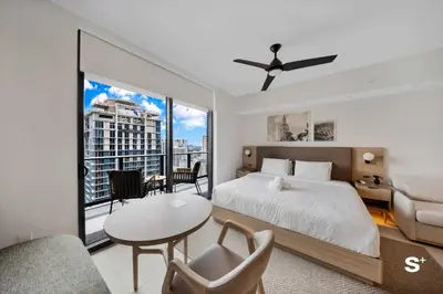 a bedroom with a bed and a table and chairs at Studio in DTW Miami - City Views & Gym in Miami