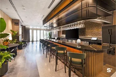 a bar in a restaurant with a bunch of stools at Studio in DTW Miami - City Views & Gym in Miami