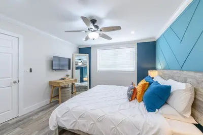 a bedroom with a bed and a ceiling fan at One block from beach South Beach Ocean Dr-King Bed in Miami Beach