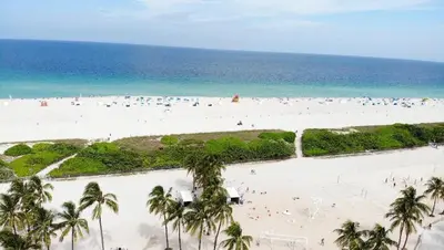 an aerial view of a beach with palm trees and the ocean at One block from beach South Beach Ocean Dr-King Bed in Miami Beach