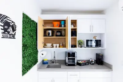 a kitchen with a counter with a sink and a microwave at HavanaDolphinsluxury 2PPL TopLocation Parking Pets in Hollywood Ridge Farms
