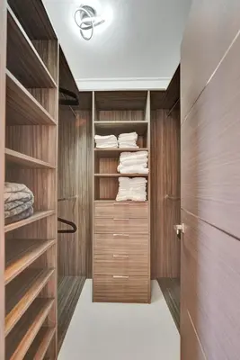 a walk in closet with wooden cabinets and towels at Luxury Oceanfront 3 Bedroom condo on the beach 16 Floor in Hollywood