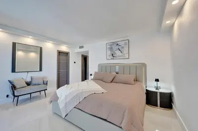 a bedroom with a large bed and a chair at Luxury Oceanfront 3 Bedroom condo on the beach 16 Floor in Hollywood