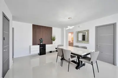 a white dining room with a table and chairs at Luxury Oceanfront 3 Bedroom condo on the beach 16 Floor in Hollywood