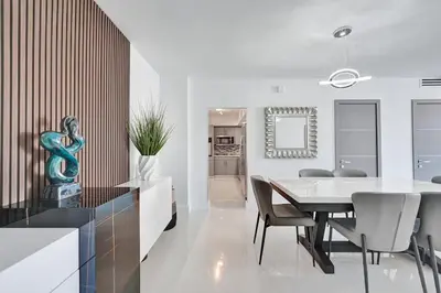 a kitchen and dining room with a table and chairs at Luxury Oceanfront 3 Bedroom condo on the beach 16 Floor in Hollywood