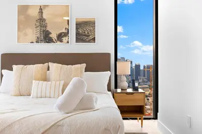 a bedroom with a bed with a view of a city at From 43th Floor a Luxury Condo Awaits For You! in Miami