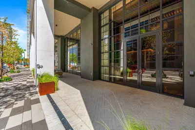 a building with glass doors on a city street at From 43th Floor a Luxury Condo Awaits For You! in Miami