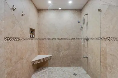 a bathroom with a shower with a glass door at Casa Brisa - Stylish BBQ Near heart of Kendall in Miami