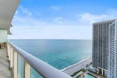 a view of the ocean from the balcony of a building at City Lights and Skyline Nights - High-Floor Stay in our Luxury Apartment in Hollywood
