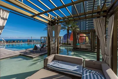 a swimming pool with a couch in front of a building at City Lights and Skyline Nights - High-Floor Stay in our Luxury Apartment in Hollywood
