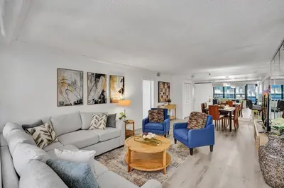 a living room with a couch and chairs and a table at Classic Resort Amenities Condo Steps from the Beach with Gym and Pool 1208 in Miami Beach