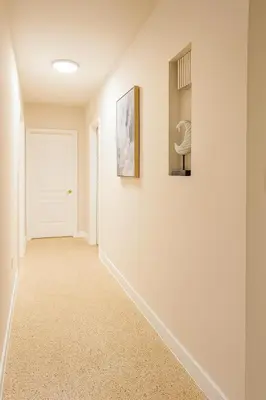 a hallway with white walls and a white door at The Awali in Miami