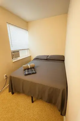 a bedroom with a bed and a window at The Awali in Miami