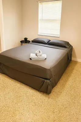 a bed with two towels on it in a bedroom at The Awali in Miami