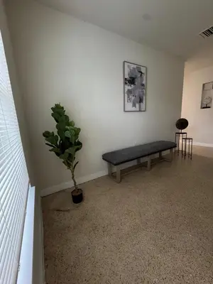 a room with a bench and a potted plant at The Awali in Miami