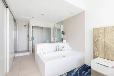 a white bathroom with a tub and a sink at 16th Floor Luxury 2 Bedroom - Ocean Views & Luxury in Fort Lauderdale
