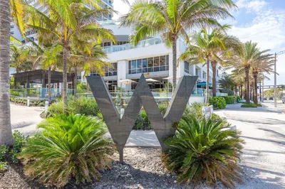 a metal x sign in front of a building at W Residences 2 Bed Unit - Beachfront and Luxe Stay in Fort Lauderdale