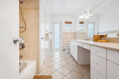 a bathroom with a tub and a sink and a toilet at Tranquil Heirloom Hideaway Pool in South Miami in Miami