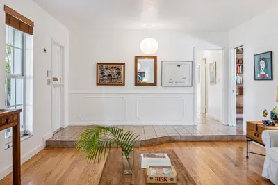 a living room with white walls and a potted plant at Tranquil Heirloom Hideaway Pool in South Miami in Miami