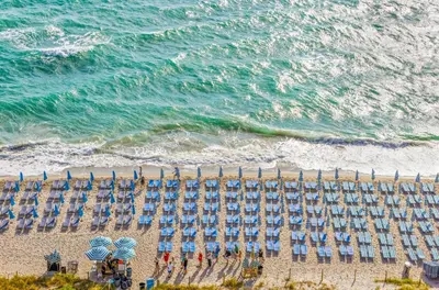 an overhead view of a beach with chairs and umbrellas at Lyfe Resort 2307 in Hollywood