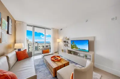 a living room with a couch and a tv at High-End Apartment in a Luxury Resort with Gorgeous Amenities in Hollywood