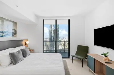 a bedroom with a large bed and a flat screen tv at Luxury 2-Bdrm Condo in the Heart of Downtown Miami in Miami