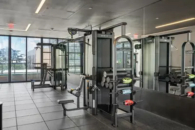 a gym with several machines and a large window at Luxury 2-Bdrm Condo in the Heart of Downtown Miami in Miami