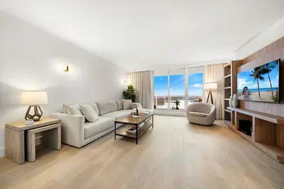 a living room with a couch and a fireplace at 1 Bedroom Private Residence at Roney Palace -1129 in Miami Beach