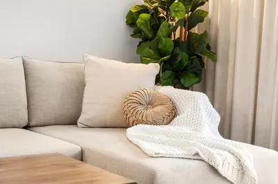a white couch with a heart pillow on it at 1 Bedroom Private Residence at Roney Palace -1129 in Miami Beach